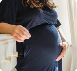 Pregnant woman touching her stomach loving speaking to baby